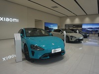 Customers buy a Xiaomi SU7 new energy vehicle at a Xiaomi Auto store in Hangzhou, China, on October 30, 2024. (