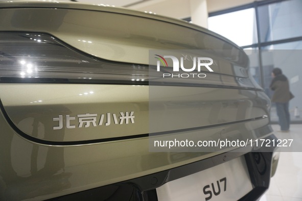 Customers buy a Xiaomi SU7 new energy vehicle at a Xiaomi Auto store in Hangzhou, China, on October 30, 2024. 