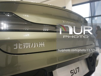 Customers buy a Xiaomi SU7 new energy vehicle at a Xiaomi Auto store in Hangzhou, China, on October 30, 2024. (