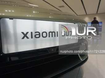 Customers buy a Xiaomi SU7 new energy vehicle at a Xiaomi Auto store in Hangzhou, China, on October 30, 2024. (