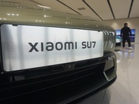 Customers buy a Xiaomi SU7 new energy vehicle at a Xiaomi Auto store in Hangzhou, China, on October 30, 2024. (