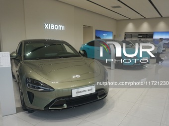 Customers buy a Xiaomi SU7 new energy vehicle at a Xiaomi Auto store in Hangzhou, China, on October 30, 2024. (