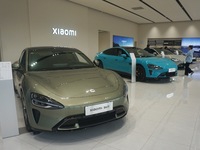 Customers buy a Xiaomi SU7 new energy vehicle at a Xiaomi Auto store in Hangzhou, China, on October 30, 2024. (