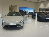 Customers buy a Xiaomi SU7 new energy vehicle at a Xiaomi Auto store in Hangzhou, China, on October 30, 2024. (