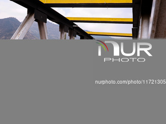 People walk on a cold morning over a bridge in Baramulla, Jammu and Kashmir, India, on October 29, 2024. (