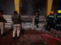 Firefighters try to douse the flames after a fire incident is reported in a commercial building in Srinagar, Jammu and Kashmir, India, on Oc...