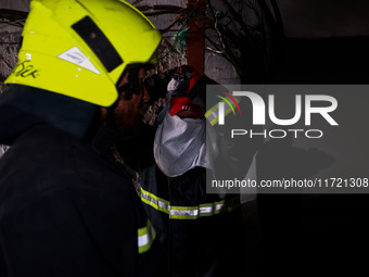 Firefighters try to douse the flames after a fire incident is reported in a commercial building in Srinagar, Jammu and Kashmir, India, on Oc...