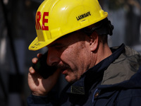 Firefighters try to douse the flames after a fire incident is reported in a commercial building in Srinagar, Jammu and Kashmir, India, on Oc...