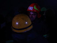 Firefighters try to douse the flames after a fire incident is reported in a commercial building in Srinagar, Jammu and Kashmir, India, on Oc...