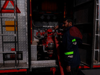 Firefighters try to douse the flames after a fire incident is reported in a commercial building in Srinagar, Jammu and Kashmir, India, on Oc...