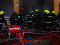 Firefighters try to douse the flames after a fire incident is reported in a commercial building in Srinagar, Jammu and Kashmir, India, on Oc...