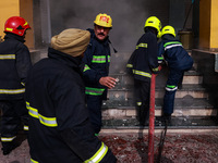 Firefighters try to douse the flames after a fire incident is reported in a commercial building in Srinagar, Jammu and Kashmir, India, on Oc...