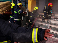 Firefighters try to douse the flames after a fire incident is reported in a commercial building in Srinagar, Jammu and Kashmir, India, on Oc...