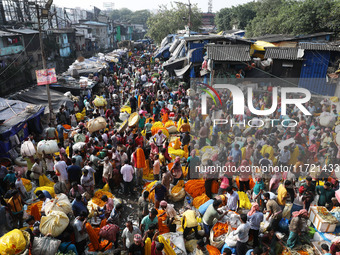 Vendors sell marigold garlands, which are used to decorate temples and homes ahead of the Diwali festival in Kolkata, India, on October 30,...