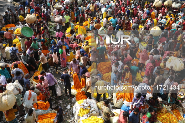 Vendors sell marigold garlands, which are used to decorate temples and homes ahead of the Diwali festival in Kolkata, India, on October 30,...