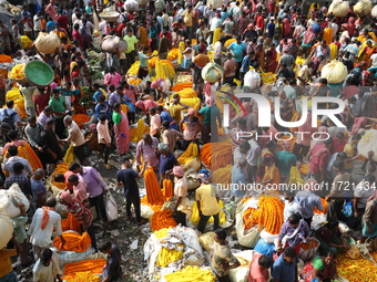 Vendors sell marigold garlands, which are used to decorate temples and homes ahead of the Diwali festival in Kolkata, India, on October 30,...