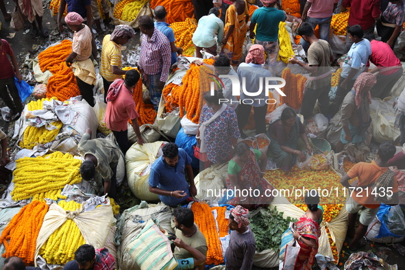 Vendors sell marigold garlands, which are used to decorate temples and homes ahead of the Diwali festival in Kolkata, India, on October 30,...