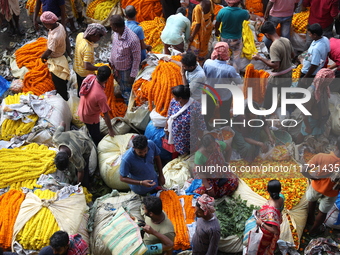 Vendors sell marigold garlands, which are used to decorate temples and homes ahead of the Diwali festival in Kolkata, India, on October 30,...