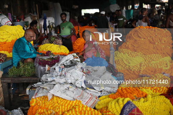 Vendors sell marigold garlands, which are used to decorate temples and homes ahead of the Diwali festival in Kolkata, India, on October 30,...