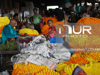 Vendors sell marigold garlands, which are used to decorate temples and homes ahead of the Diwali festival in Kolkata, India, on October 30,...