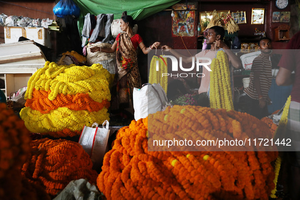 Vendors sell marigold garlands, which are used to decorate temples and homes ahead of the Diwali festival in Kolkata, India, on October 30,...