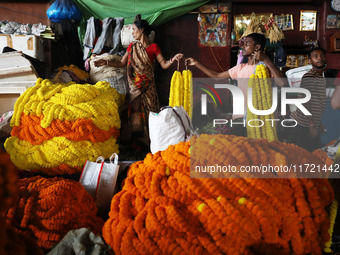 Vendors sell marigold garlands, which are used to decorate temples and homes ahead of the Diwali festival in Kolkata, India, on October 30,...