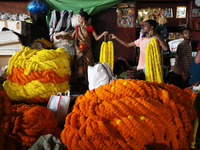 Vendors sell marigold garlands, which are used to decorate temples and homes ahead of the Diwali festival in Kolkata, India, on October 30,...