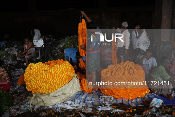 Vendors sell marigold garlands, which are used to decorate temples and homes ahead of the Diwali festival in Kolkata, India, on October 30,...