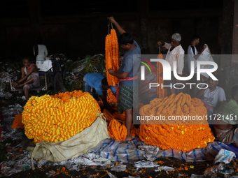 Vendors sell marigold garlands, which are used to decorate temples and homes ahead of the Diwali festival in Kolkata, India, on October 30,...