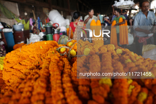 Vendors sell marigold garlands, which are used to decorate temples and homes ahead of the Diwali festival in Kolkata, India, on October 30,...