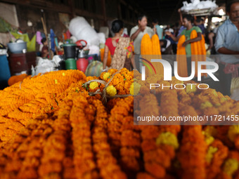 Vendors sell marigold garlands, which are used to decorate temples and homes ahead of the Diwali festival in Kolkata, India, on October 30,...