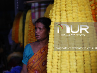 A vendor sells marigold garlands, which are used to decorate temples and homes ahead of the Diwali festival in Kolkata, India, on October 30...