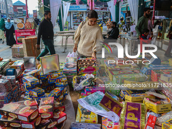 Customers buy firecrackers at a market ahead of Diwali, the Hindu festival of lights, in Srinagar, Jammu and Kashmir, on October 30, 2024. (