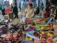 Customers buy firecrackers at a market ahead of Diwali, the Hindu festival of lights, in Srinagar, Jammu and Kashmir, on October 30, 2024. (