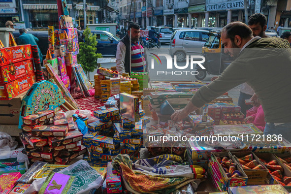 Customers buy firecrackers at a market ahead of Diwali, the Hindu festival of lights, in Srinagar, Jammu and Kashmir, on October 30, 2024. 