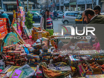 Customers buy firecrackers at a market ahead of Diwali, the Hindu festival of lights, in Srinagar, Jammu and Kashmir, on October 30, 2024. (