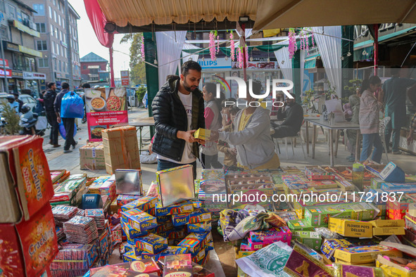 Customers buy firecrackers at a market ahead of Diwali, the Hindu festival of lights, in Srinagar, Jammu and Kashmir, on October 30, 2024. 