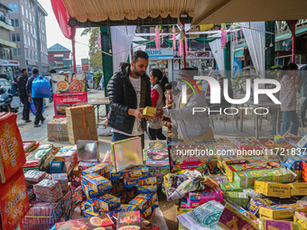 Customers buy firecrackers at a market ahead of Diwali, the Hindu festival of lights, in Srinagar, Jammu and Kashmir, on October 30, 2024. (