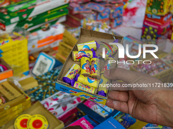 Customers buy firecrackers at a market ahead of Diwali, the Hindu festival of lights, in Srinagar, Jammu and Kashmir, on October 30, 2024. (