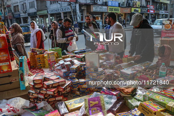 Customers buy firecrackers at a market ahead of Diwali, the Hindu festival of lights, in Srinagar, Jammu and Kashmir, on October 30, 2024. 