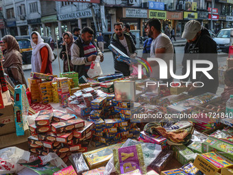 Customers buy firecrackers at a market ahead of Diwali, the Hindu festival of lights, in Srinagar, Jammu and Kashmir, on October 30, 2024. (