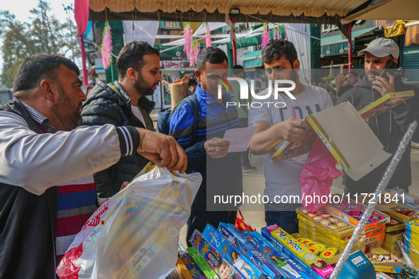 Customers buy firecrackers at a market ahead of Diwali, the Hindu festival of lights, in Srinagar, Jammu and Kashmir, on October 30, 2024. 