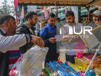 Customers buy firecrackers at a market ahead of Diwali, the Hindu festival of lights, in Srinagar, Jammu and Kashmir, on October 30, 2024. (