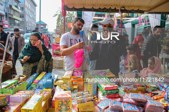 Customers buy firecrackers at a market ahead of Diwali, the Hindu festival of lights, in Srinagar, Jammu and Kashmir, on October 30, 2024. 