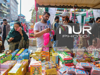 Customers buy firecrackers at a market ahead of Diwali, the Hindu festival of lights, in Srinagar, Jammu and Kashmir, on October 30, 2024. (