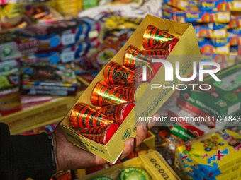 Customers buy firecrackers at a market ahead of Diwali, the Hindu festival of lights, in Srinagar, Jammu and Kashmir, on October 30, 2024. (