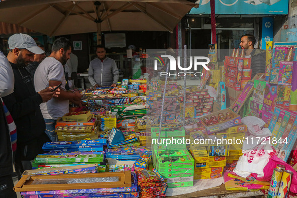 Customers buy firecrackers at a market ahead of Diwali, the Hindu festival of lights, in Srinagar, Jammu and Kashmir, on October 30, 2024. 