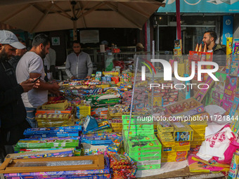 Customers buy firecrackers at a market ahead of Diwali, the Hindu festival of lights, in Srinagar, Jammu and Kashmir, on October 30, 2024. (