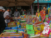 Customers buy firecrackers at a market ahead of Diwali, the Hindu festival of lights, in Srinagar, Jammu and Kashmir, on October 30, 2024. (