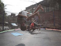 Children jump on a trampoline at a fair outside a ''pandal,'' a decorated temporary platform, ahead of the Kali Puja festival in Kolkata, In...